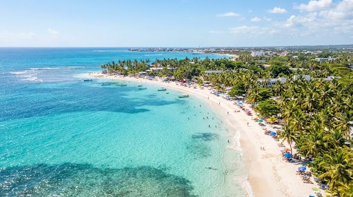 Vista aérea de la playa de Boca Chica con aguas turquesas y palmeras